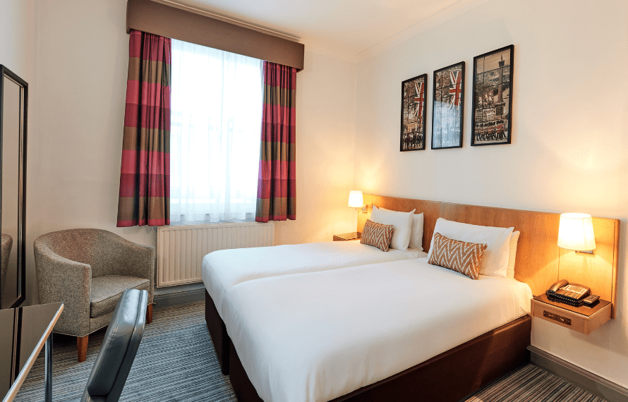 Twin room at thistle bloomsbury park with twin beds desk and armchair