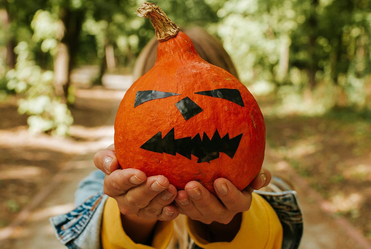 Close up of a child holding a pumpkin
