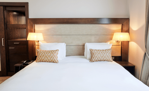 Close up of bed with bedside lamps