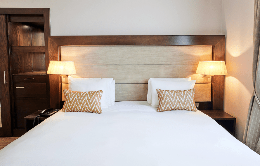 Close up of bed with bedside lamps