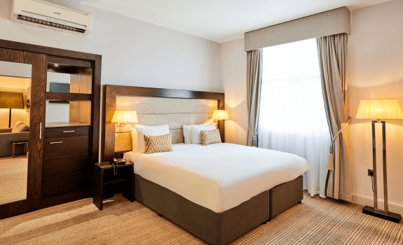 Bed in junior suite with lamps