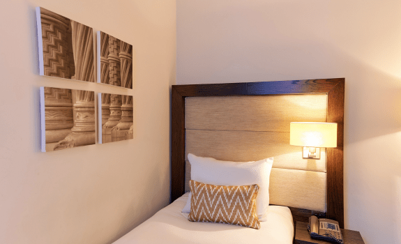 Close up of dingle bed and art on the wall