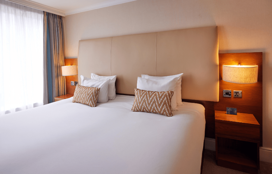 Close up of king bed and bedside table