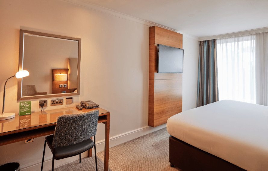 Desk, bed and TV in deluxe king bedroom