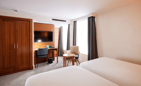 Twin beds, desk area and wardrobe