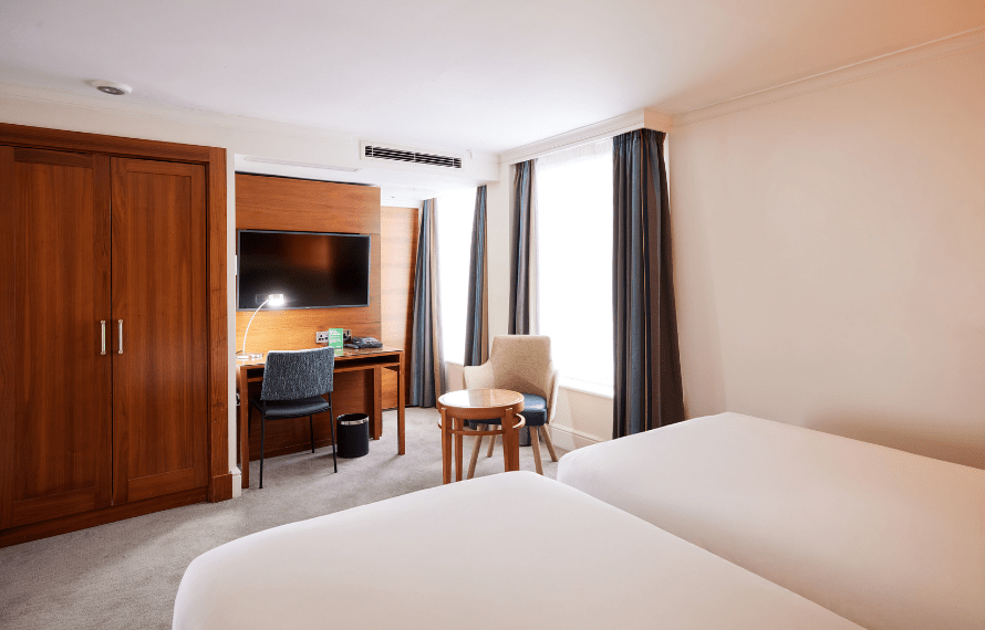 Twin beds, desk area and wardrobe
