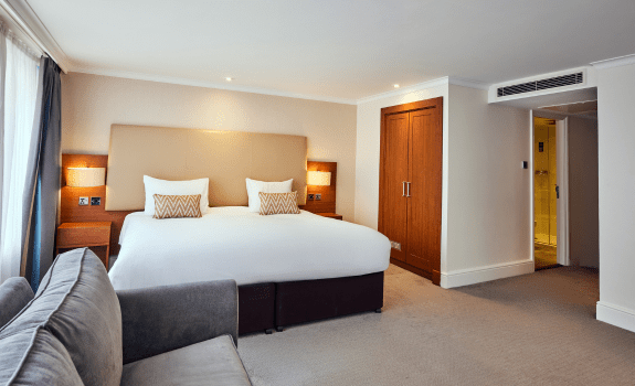 Bed in junior suite with sofa