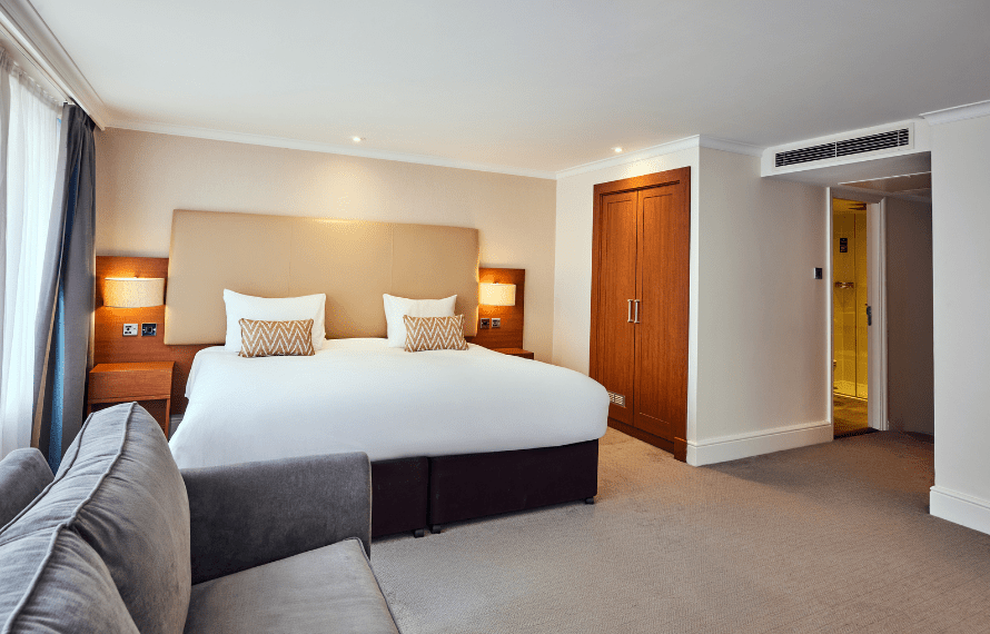 Bed in junior suite with sofa