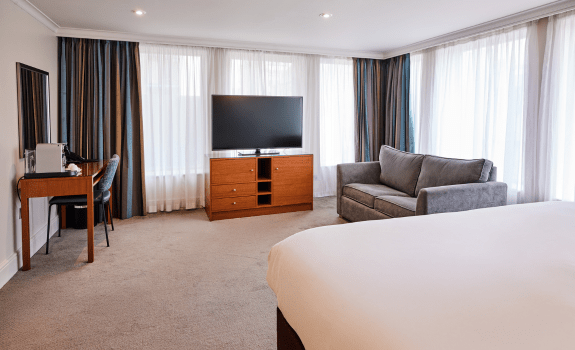 Junior suite with sofa and TV