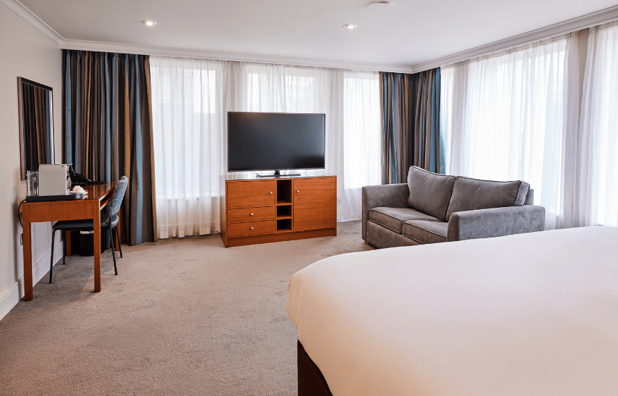 Junior suite with sofa and TV