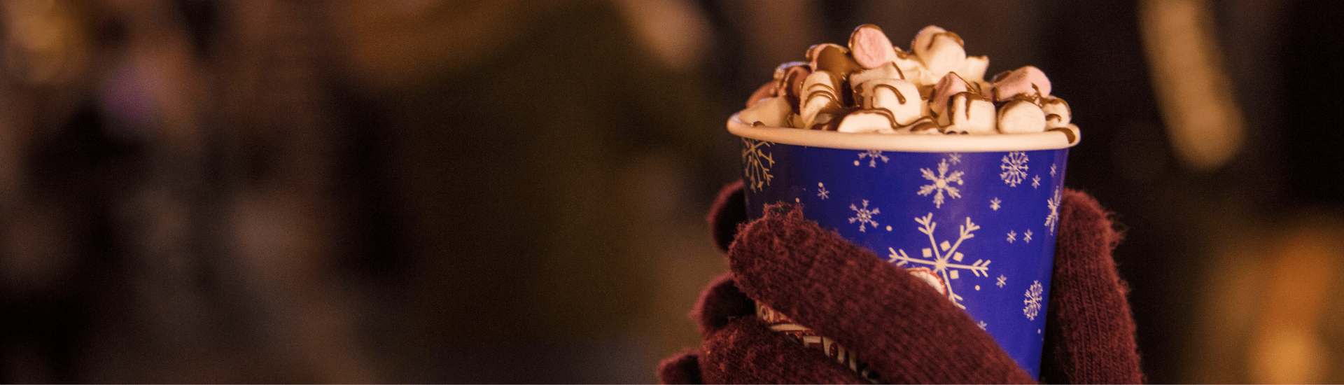 Gloved hand holding hot chocolate