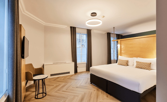 Apartment bedroom with king bed and desk