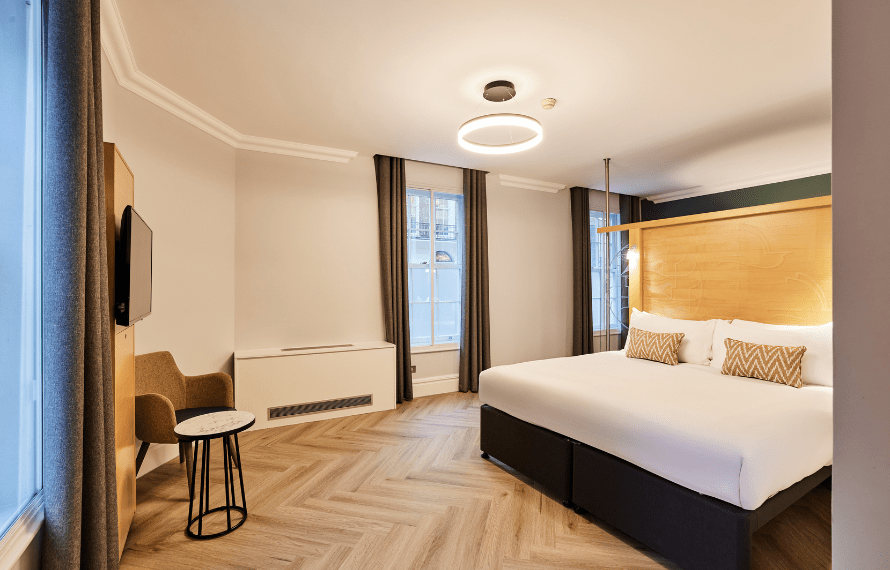 Apartment bedroom with king bed and desk