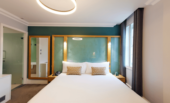 View of double bed from the feet of the bed