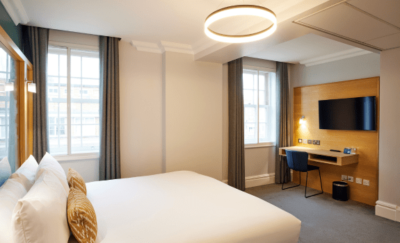 Double bedroom with bed, windows and desk