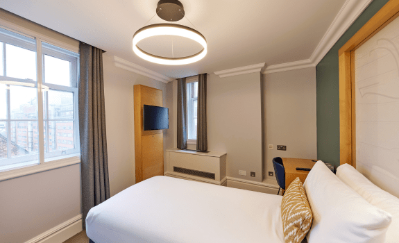 Single bed, desk area and TV