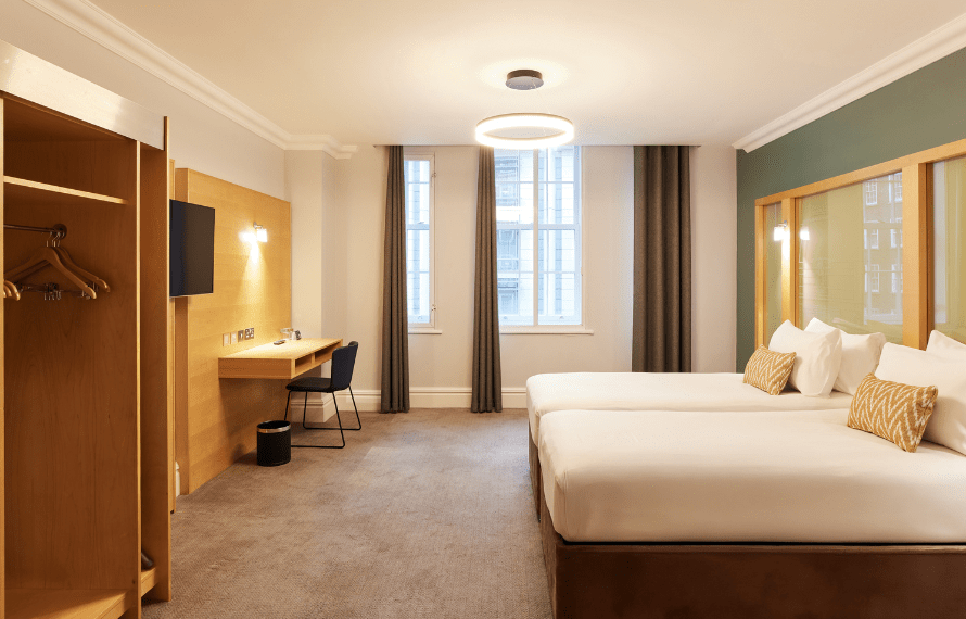 View of twin beds, wardrobe and desk