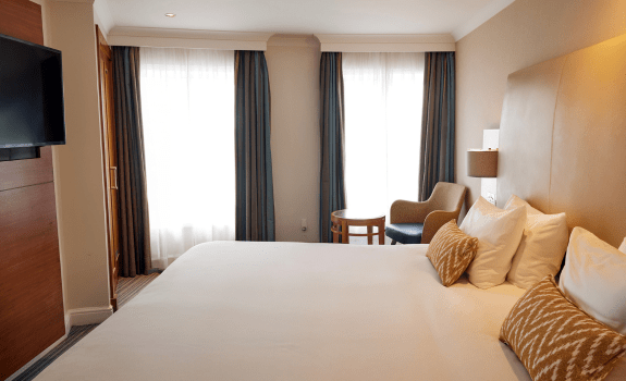 King bed and TV in deluxe king bedroom