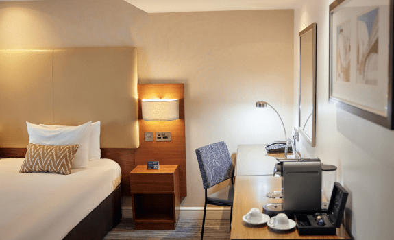 Desk and coffee machine in deluxe king bedroom