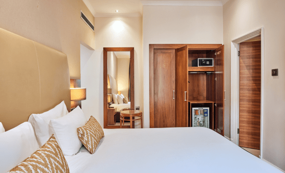 Bed and wardrobe at Thistle Piccadilly hotel