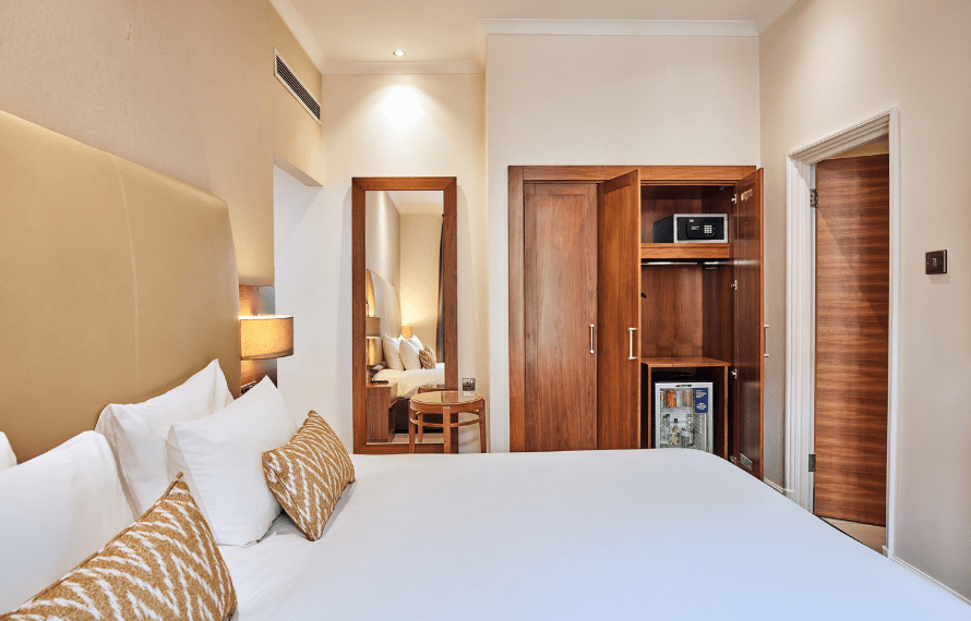 Bed and wardrobe at Thistle Piccadilly hotel