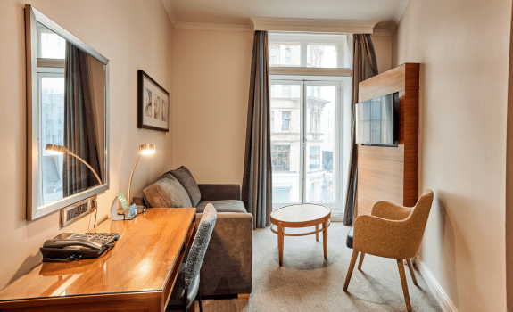 Sofa, desk and TV in junior suite