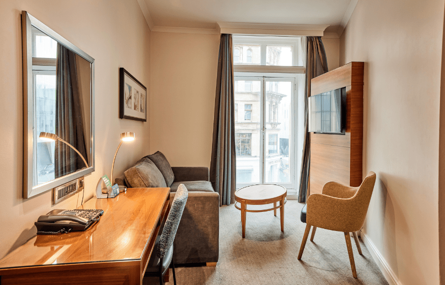 Sofa, desk and TV in junior suite