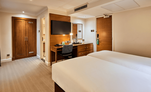 Twin beds, desk and TV