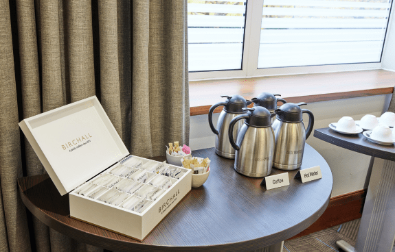 Tea and tea mugs in meeting room