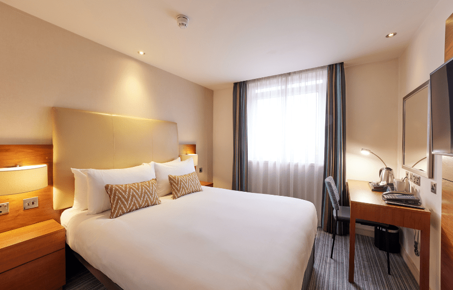 Double bed in double room with desk