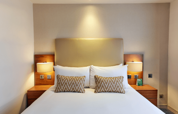 View of the bed in the double room with bedside tables